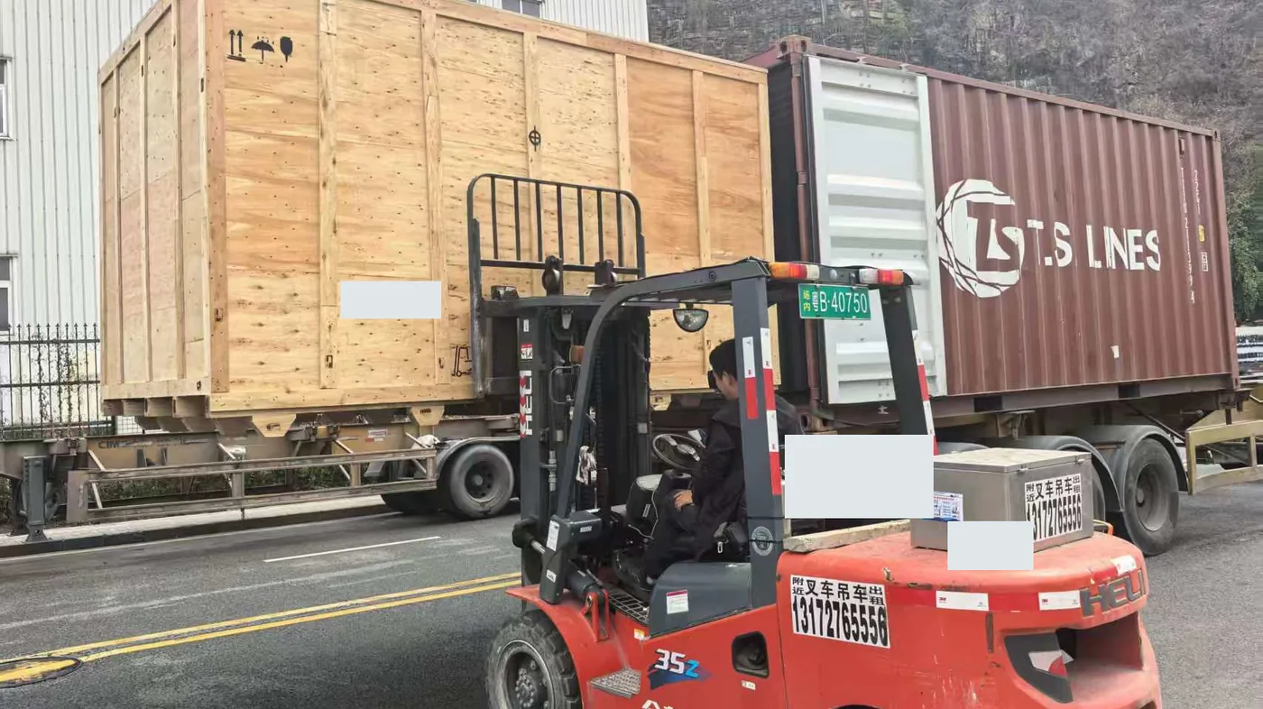 Oversized wooden crate being loaded by forklift for ocean freight
